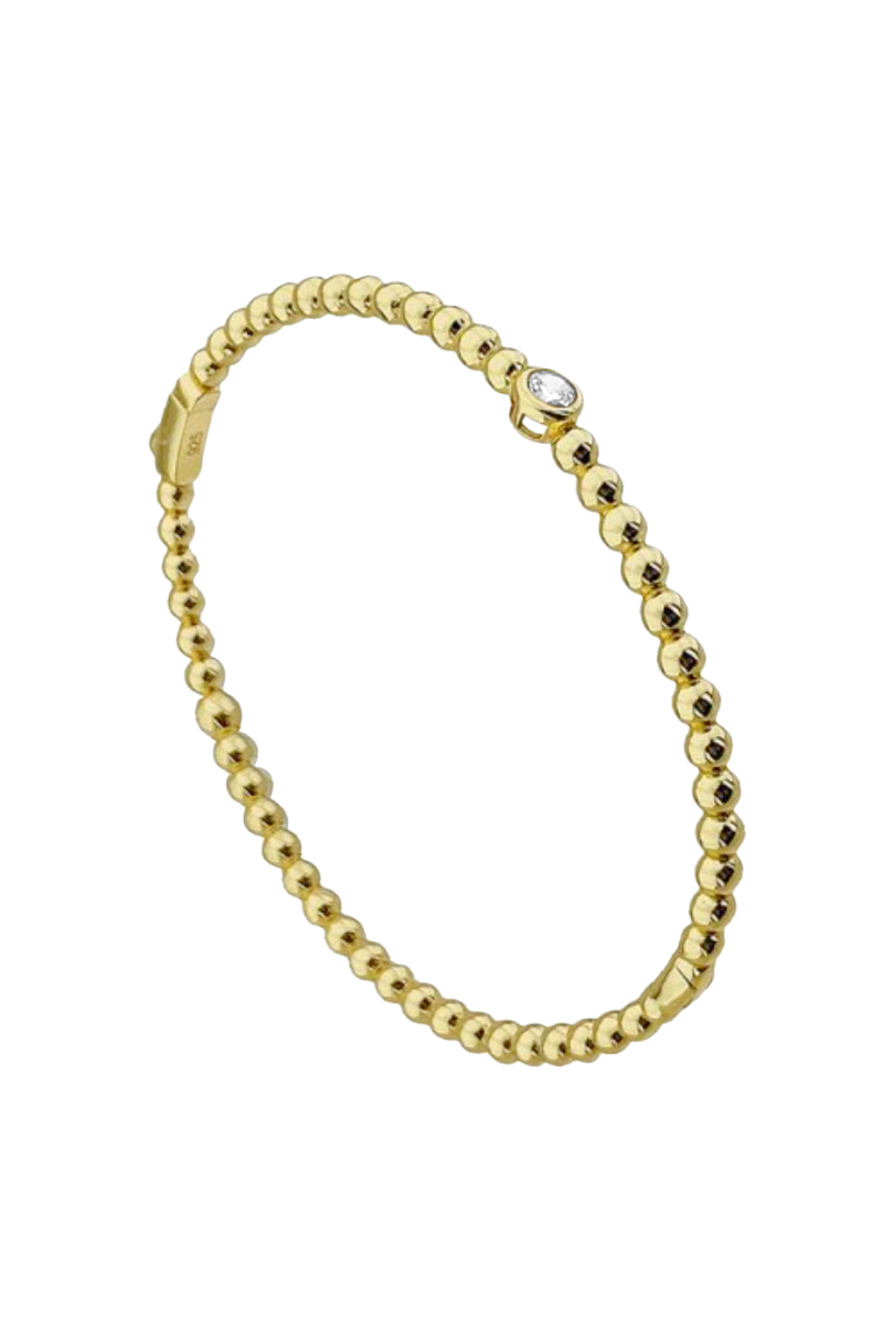 a gold bracelet with a diamond