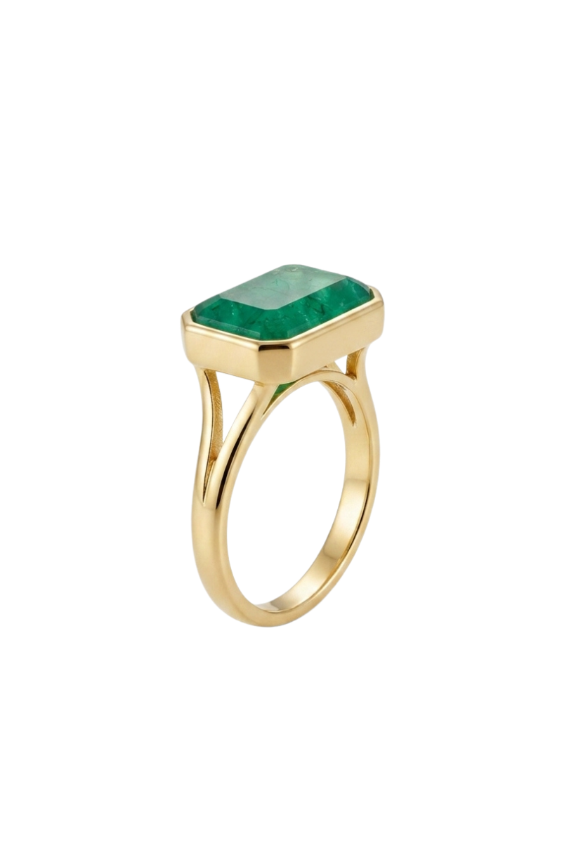a gold ring with a green gem