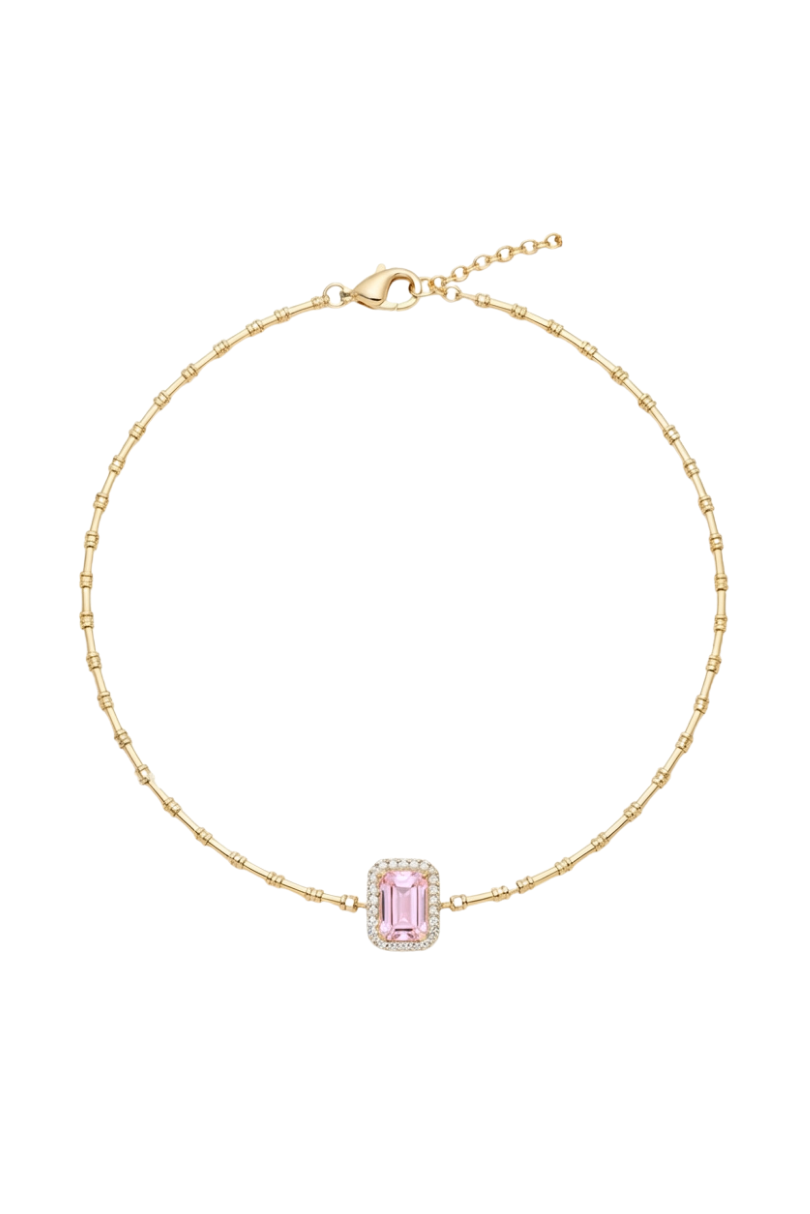 a gold bracelet with a pink stone and diamonds